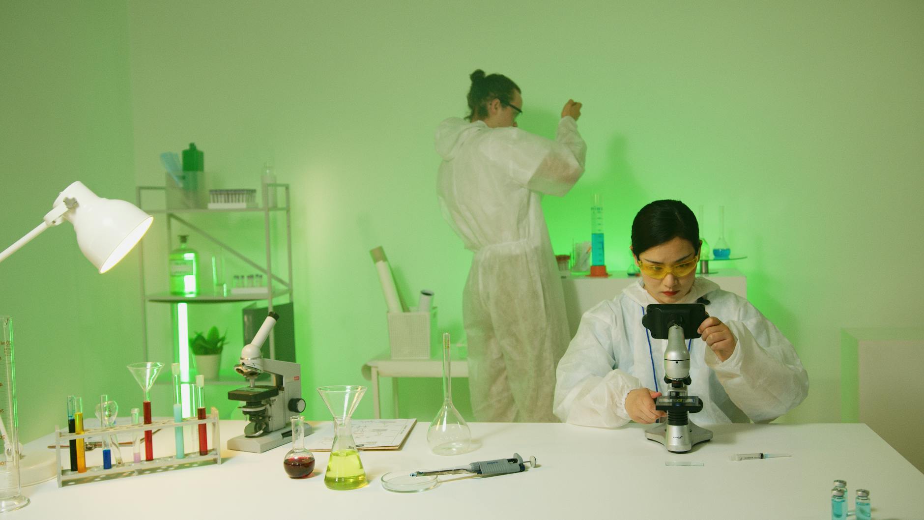 Scientists in protective gear conducting biotech research in a laboratory