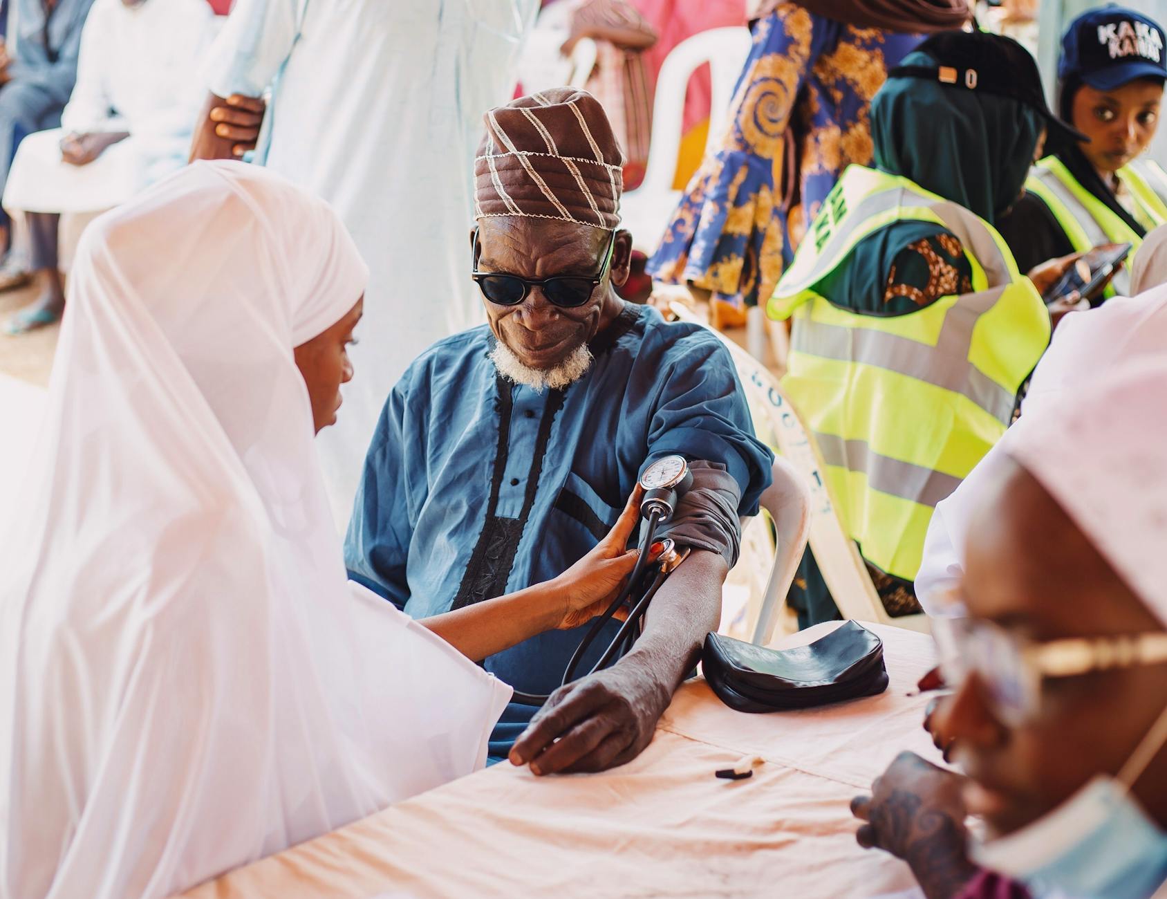 Community health care worker assisting an elderly patient